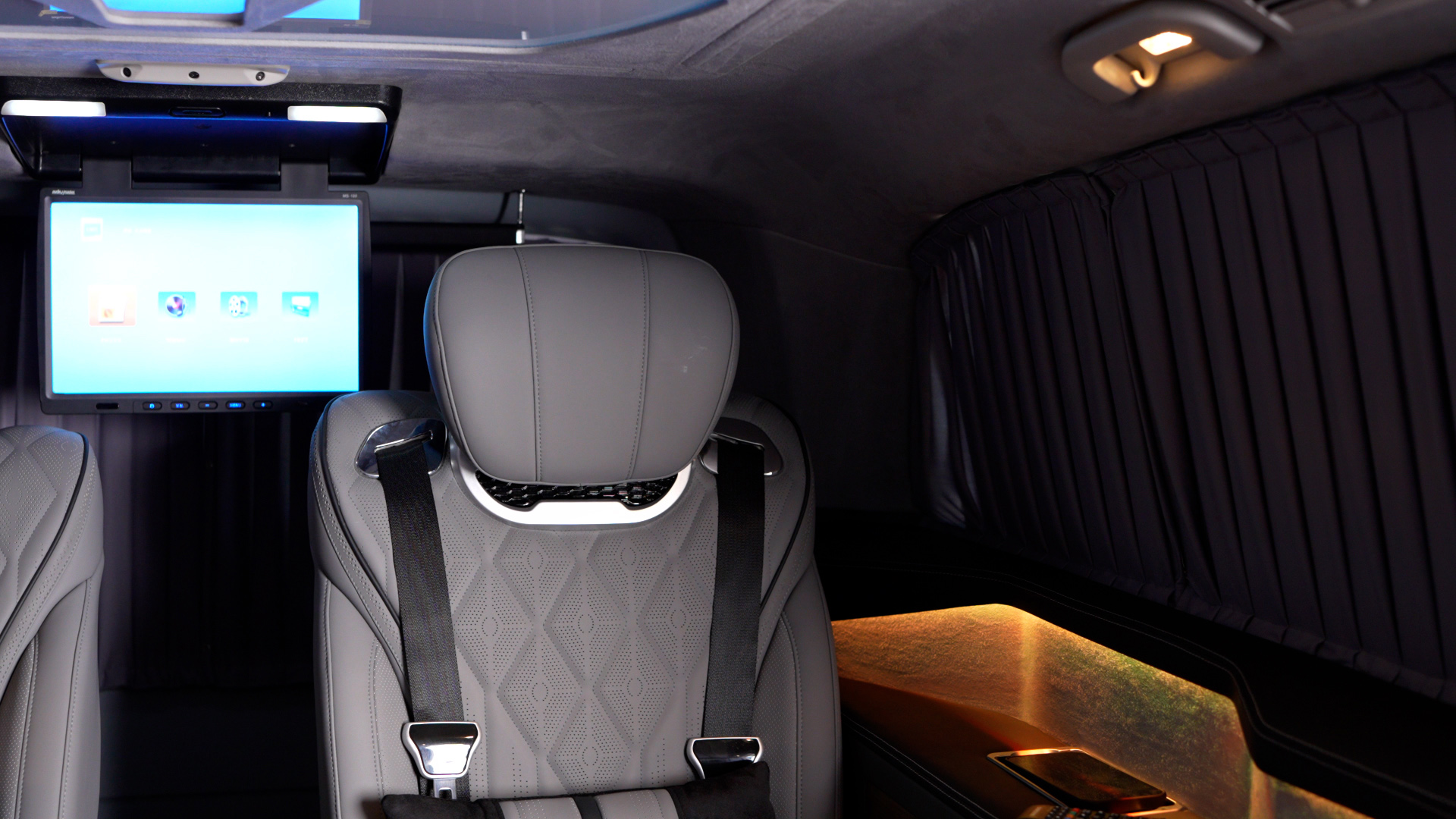 Individual leather passenger seat with entertainment screen and privacy curtains in the Vito VIP cabin
