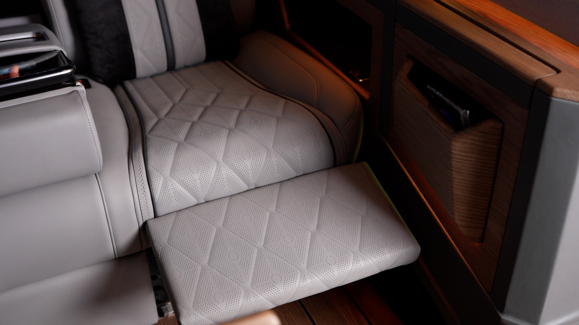 Extended leather passenger seat leg rest inside the Ilesbus Vito VIP